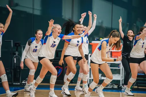 The team runs on the court as the match is won