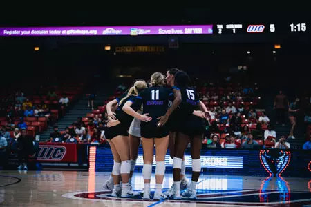 DePaul volleyball huddles on the court at UIC