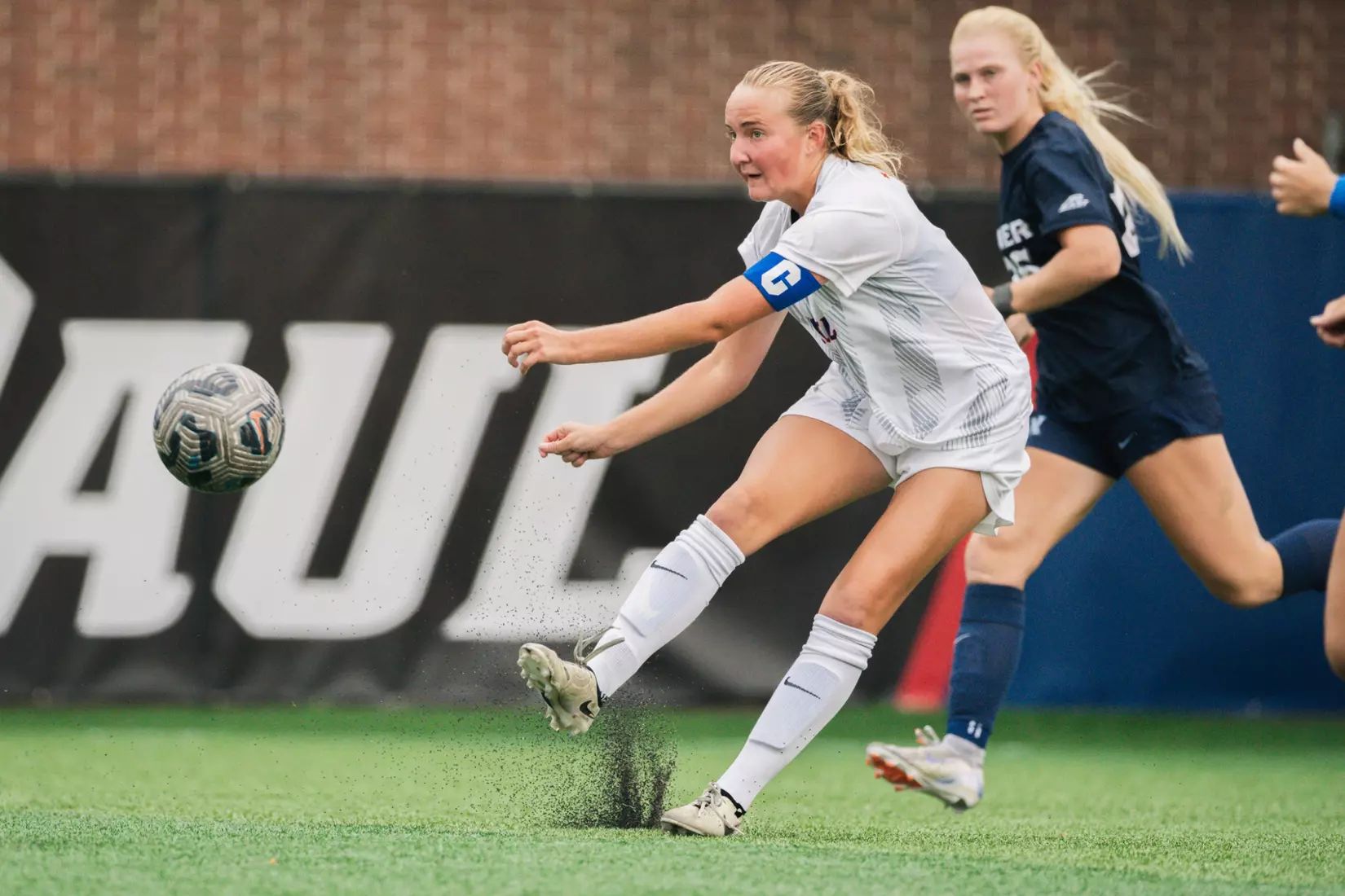 Captain midfielder Danielle Fjeldsted plays the ball downfield.