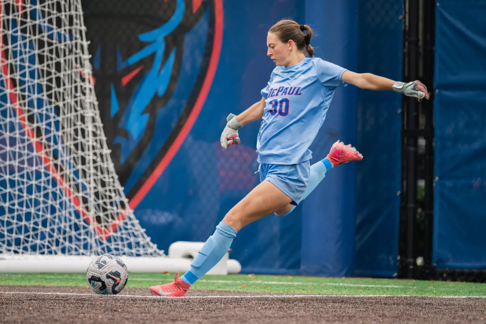 Junior goalkeeper Mason Hillery boots the ball downfield on a goal kick.
