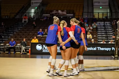 DePaul volleyball huddles on court