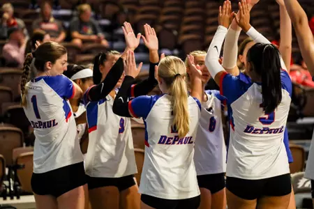 DePaul volleyball team high-fives before a match
