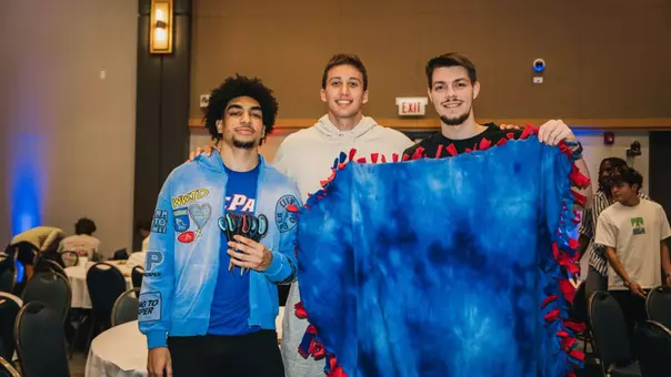 Men's basketball student-athletes complete blankets for Marillac St. Vincent.