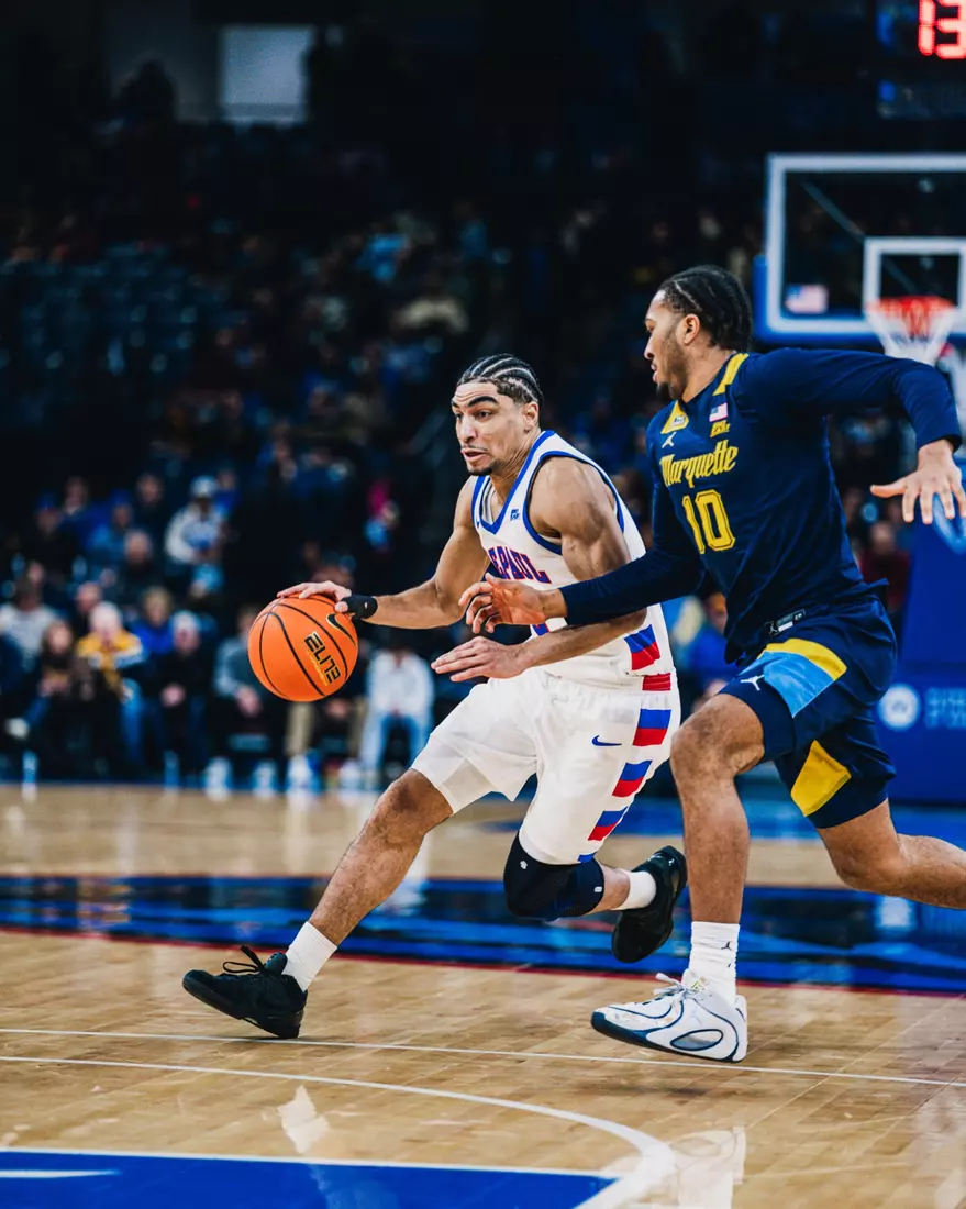 RJ Smith dribbling down the court.