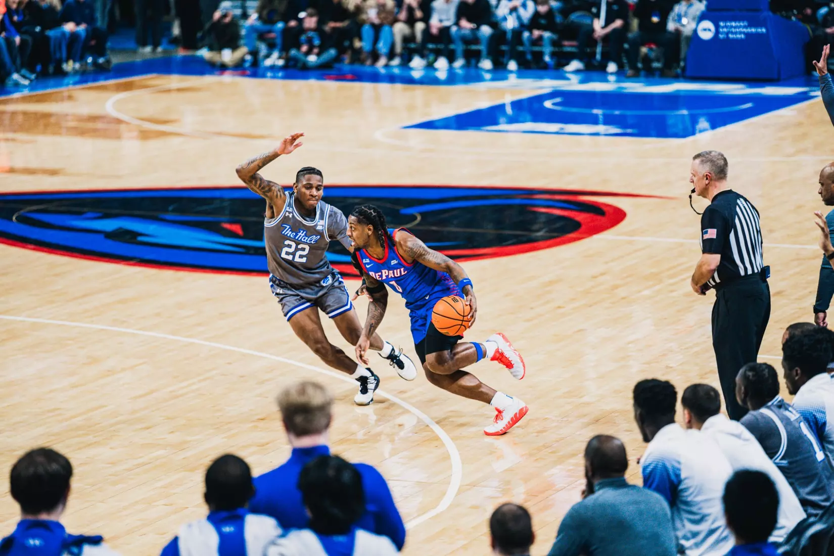 Brandon Maclin drives in on former DePaul player Elijah Fisher.