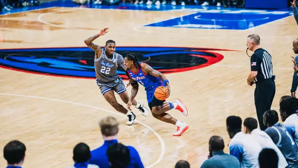 Brandon Maclin drives in on former DePaul player Elijah Fisher.