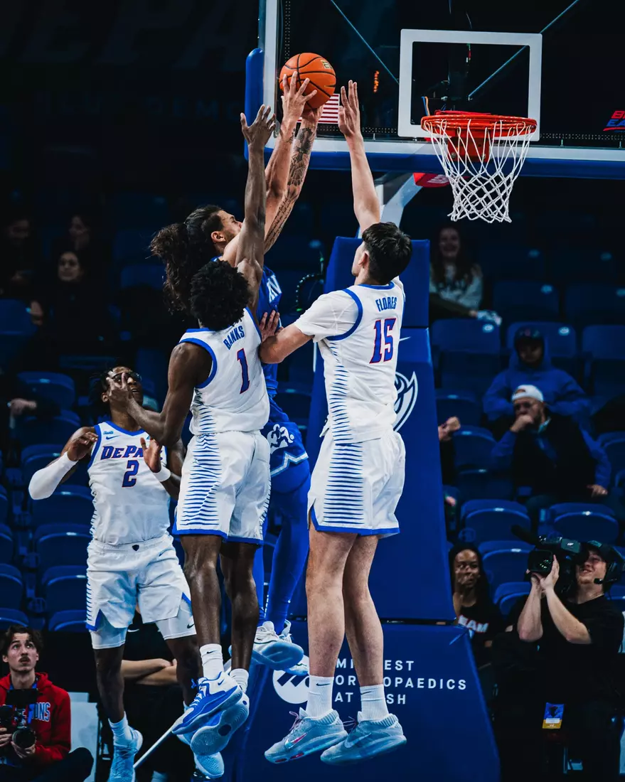 Kaleb Banks and Fabián Flores raise up to block the Xavier attempt.