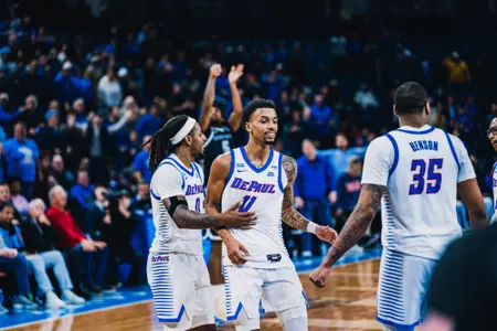 CJ Gunn, Brandon Maclin, and NJ Benson celebrate.