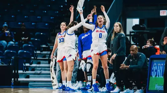 The bench celebrates after a three.
