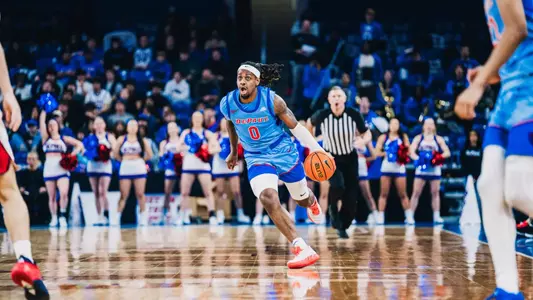 Brandon Maclin dribbles the ball up the court.
