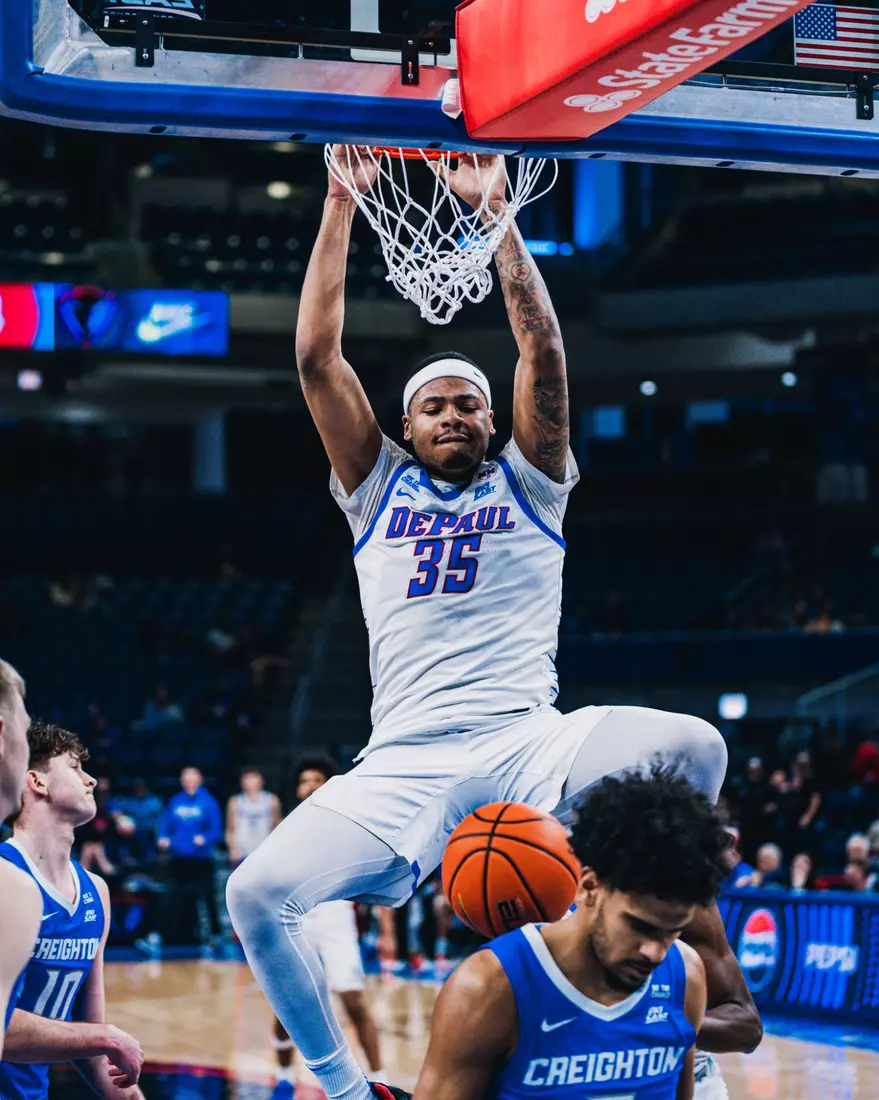 Forward NJ Benson finishes the slam over the Creighton defender.