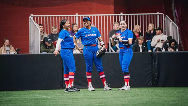 Jolie Adams, Kali Blount, Addy Poe standing in outfield