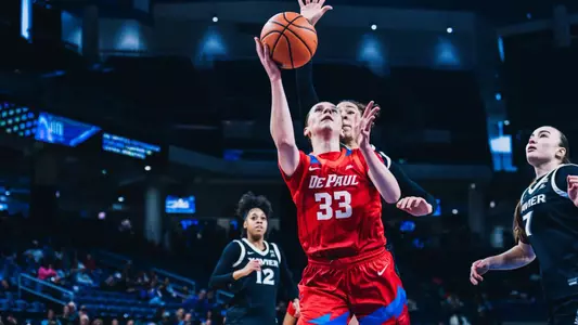 Kate Novik attempts a layup past a defender.