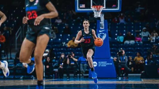 Kate Novik dribbles up the court