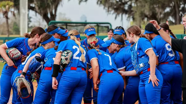 Softball team huddles before a game