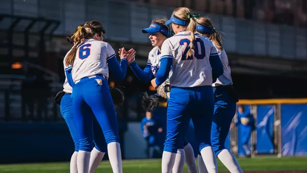 DePaul softball huddles at the mound