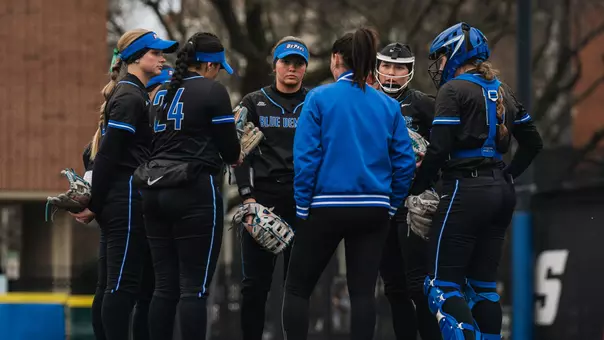 Depaul softball huddles at mound