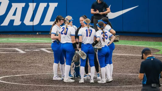 Softball infield meets at the mound
