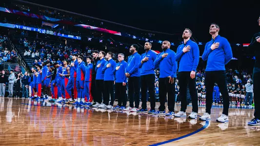 coaching staff during national anthem