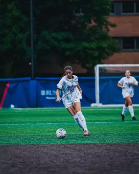Shayna da Silva is dribbling the ball down the field.