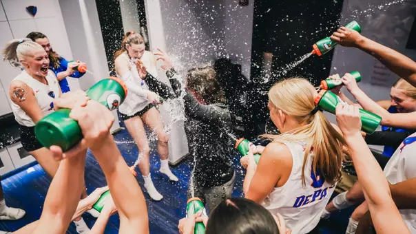 Marie Zidek DePaul volleyball team celebrates win over Marquette with water in locker room
