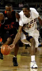 Tyrone Beale flicks the ball away from Saint Paul's Antonio Hargrove, left, during the first half of a college basketball game Saturday, Jan. 7, 2006. East Carolina won 80-74. (AP Photo/East Carolina University, Marc J. Kawanishi)
