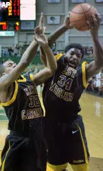 Gabe Blair (32) and Brandon Evans (34) go up for a rebound during the first half. (AP Photo/Jeff Gentner)