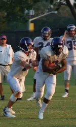 QB Brett Clay runs through handoff drills during the early stages of Thursday's practice.