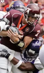 Virginia Tech quarterback Sean Glennon (7) gets sacked by East Carolina defenders during the the first half of a college football game at Lane Stadium in Blacksburg, Va. (AP Photo/Steve Helber)