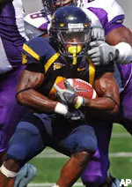 West Virginia's Steve Slaton is brought down by East Carolina's Khalif Mitchell (98) during the second half. (AP Photo/Jeff Gentner)