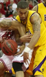 NC State's Johnny Thomas and ECU's Jamar Abrams go after a loose ball during the first half.