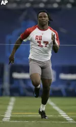 Running back Chris Johnson, of East Carolina, runs the 40-yard dash at the NFL Combine in Indianapolis, Sunday, Feb. 24, 2008. (AP Photo/Michael Conroy)