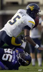 C.J. Wilson sacks West Virginia's quarterback Pat White during the third quarter. (AP Photo/Sara D. Davis)