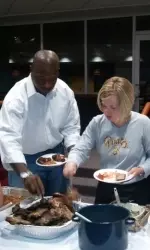 Coach Wheel and Coach Macy fill up their plates at the annual preseason potluck Wednesday
