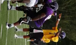 Freshman quarterback Rio Johnson points out the defense during Friday morning's practice.