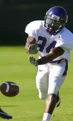 Sophomore Torrance Hunt extends his hands to block a punt during ECU's practice.