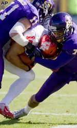 East Carolina's Damon Magazu (11) and Lamar Ivey (7) tackle Houston's Shane Ros (19).