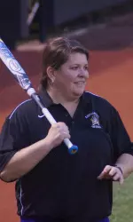 Head coach Beth Keylon-Randolph hits grounders to the infield during practice on Sunday.