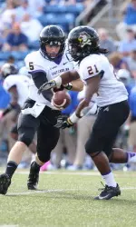 QB Shane Carden hands the ball off to RB Vintavious Cooper