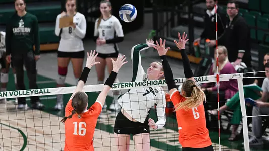 Mackenzie Gross looks to spike over two Bowling Green defenders