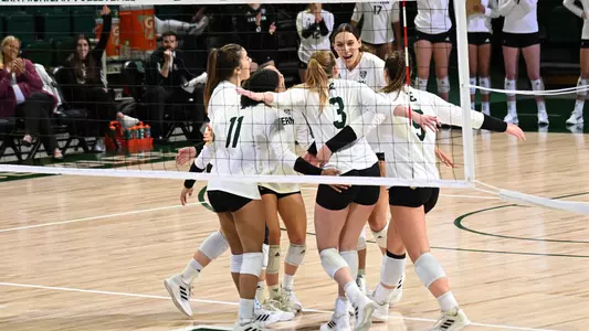 Mekayla Koger celebrates with team after a point