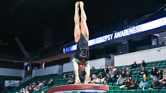 Alana Fisher twisting off the table during vault against Kent State