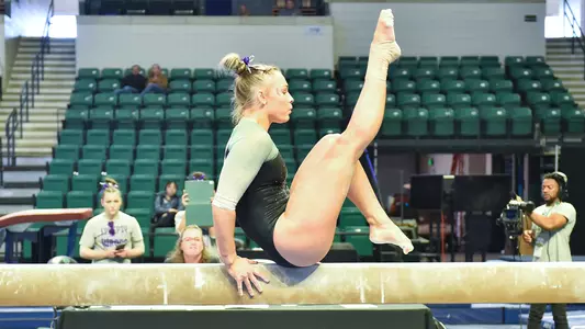 Katie Butler competing as a beam exhibition against Kent State 2/26/23