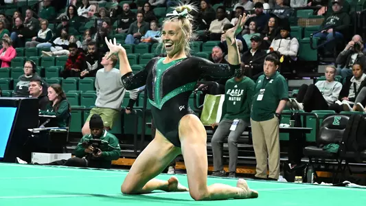AG McCullough on knees during floor routine at BGSU meet