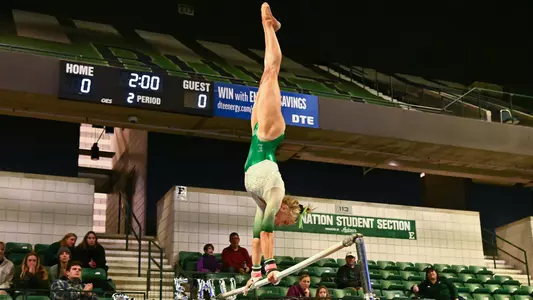 AG McCullough twists during bars handstand against Ball State