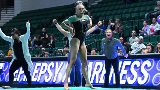 AG McCullough smiles during floor routine against Kent State