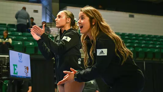 Mickayla Stuckey and Cali Harden assist with vault routines at BGSU meet