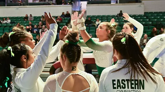 Emma Lewis getting high fives after vaulting against Ball State