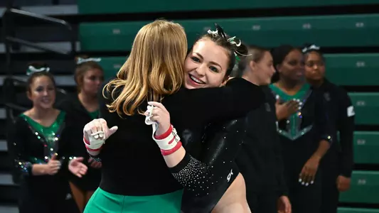 Hannah Hartung hugs Katie Minasola after BGSU bars routine
