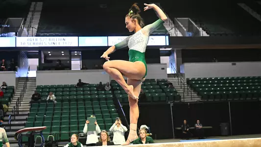 Jordan Jankowski performing a beam exhibition routine against Ball State